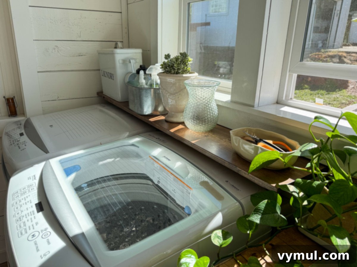 wood shelf over top of top loading washer and dryer