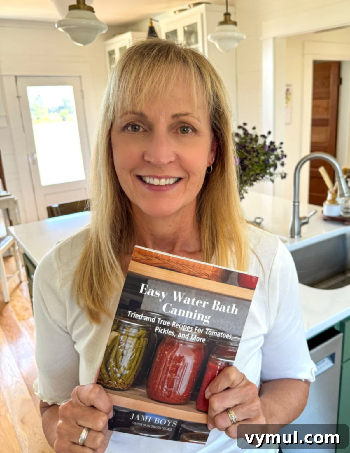 holding copy of canning cookbook