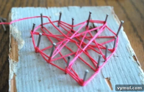 Close-up of string art heart showing intricate floss weaving