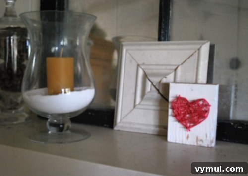 Finished string art heart on a rustic mantelpiece