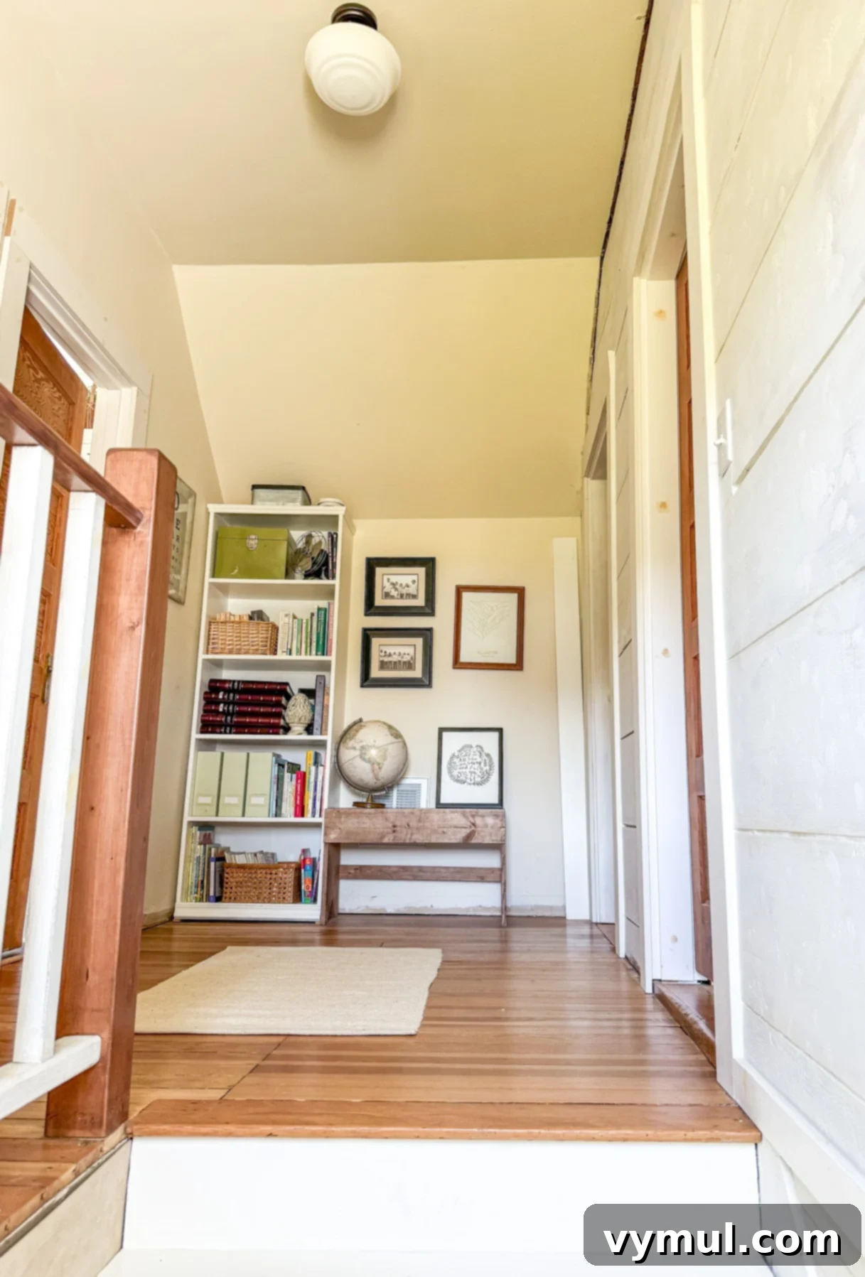 Beautifully remodeled upstairs landing in a 1900 farmhouse, featuring a refurbished stairwell and vintage details.