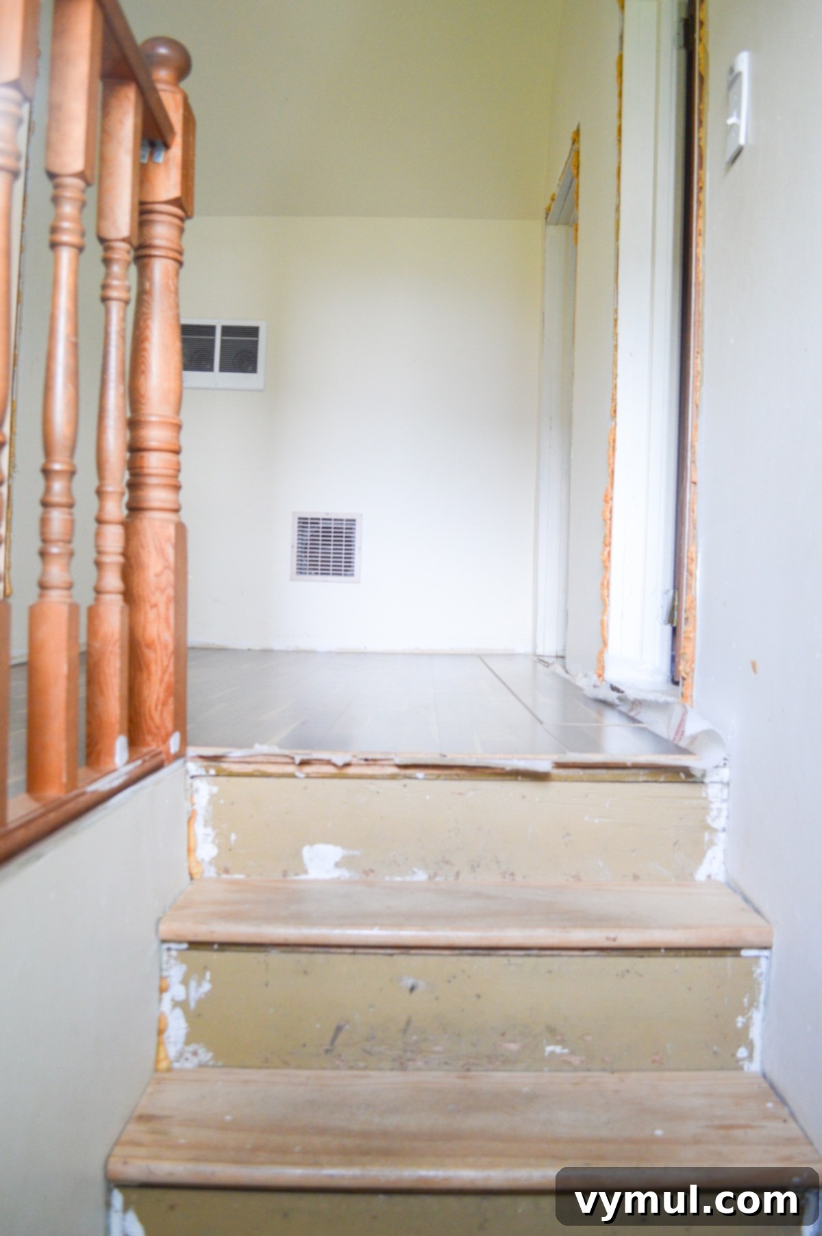 Dilapidated upstairs landing before any farmhouse renovation work began.