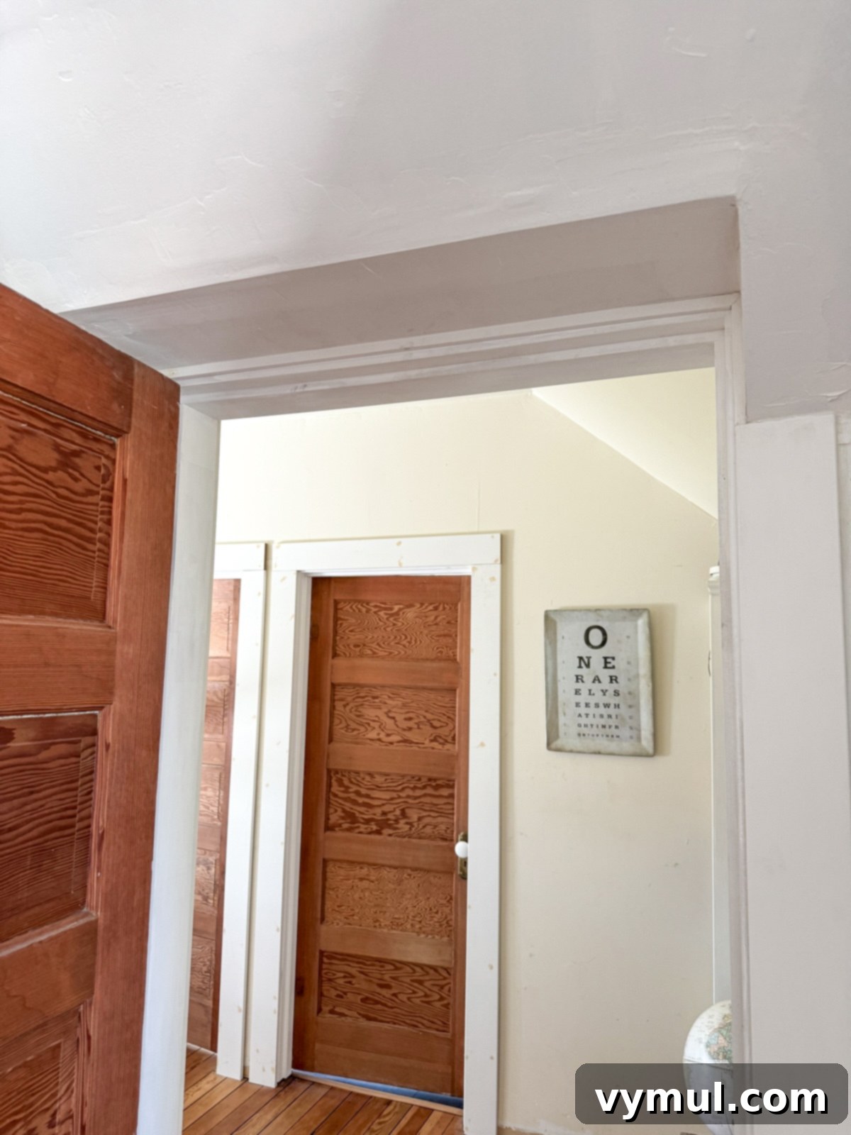 Detail shot of a doorway expertly extended to full height in a renovated farmhouse.