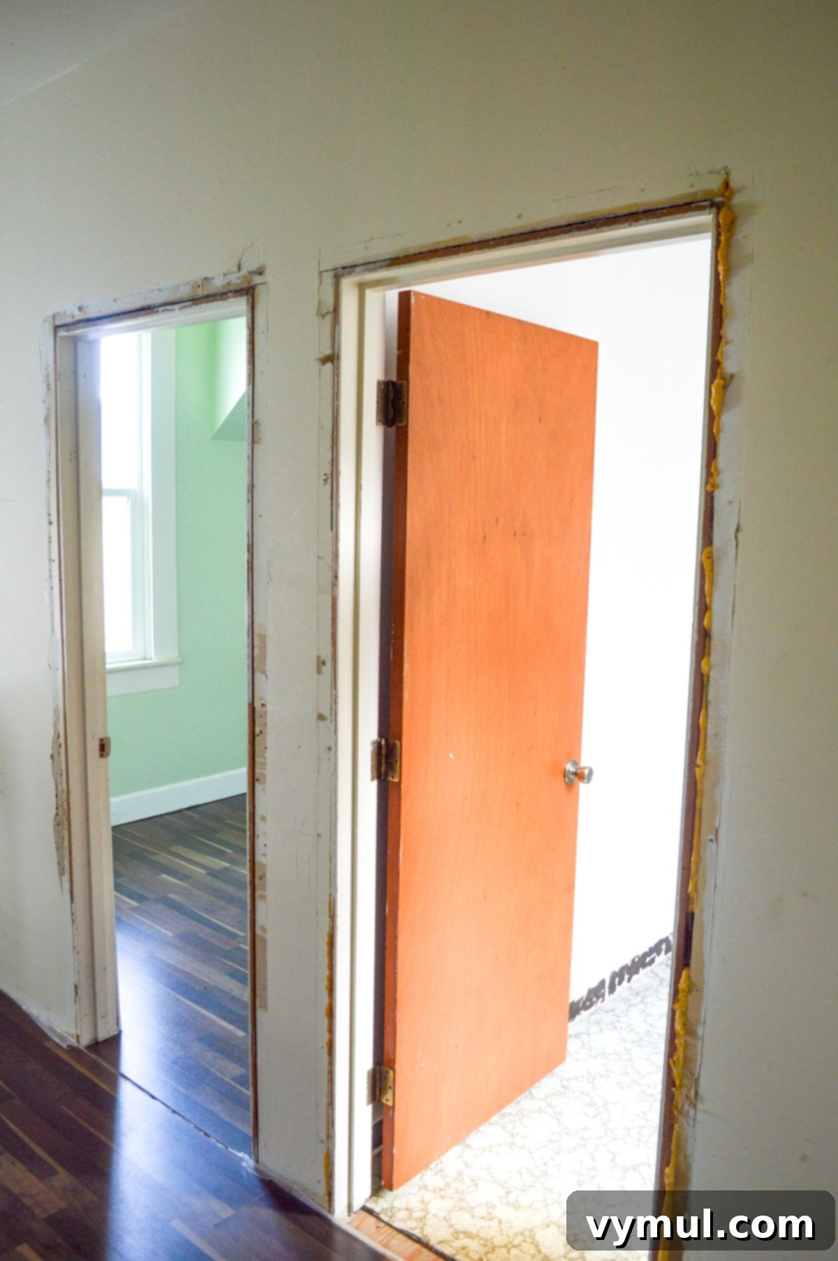 Before shot of bath and office doors, lacking character and proper trim.