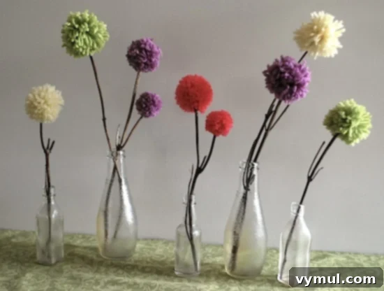Easy and Adorable Pom Pom Flowers for Spring 4 Pom pom flowers displayed in small glass bottles
