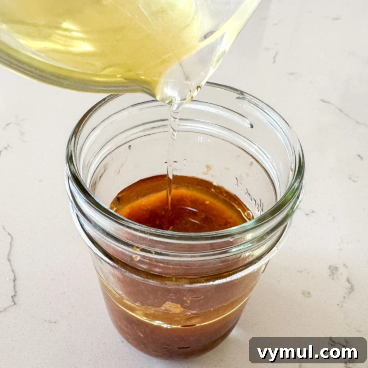 adding tomato vinaigrette ingredients to jar