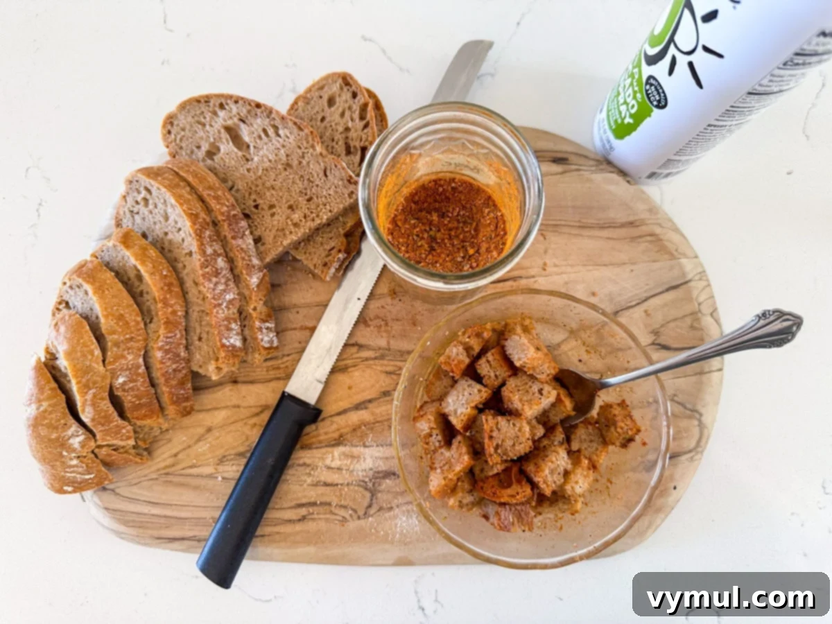 Perfect Pan-Seared Salmon Caesar 3 Cubed bread on a cutting board, tossed with olive oil and spices, ready for the air fryer.
