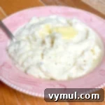 garlic mashed potatoes in red serving bowl