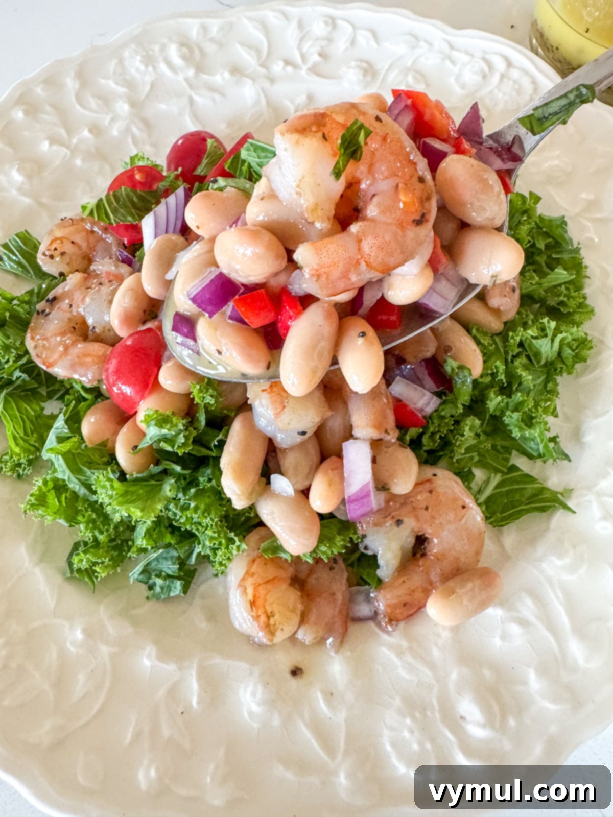 Effortless 15-Minute White Bean Salad with Shrimp or Chicken 5 serving white bean salad on bed of greens