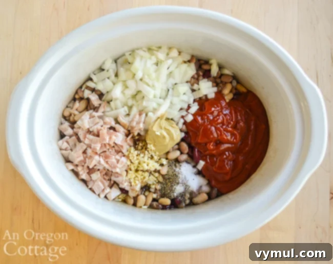 Slow Cooker Honey Baked Beans with Maple Variation 5 All ingredients for slow cooker honey baked beans placed together in the slow cooker pot, ready for stirring.