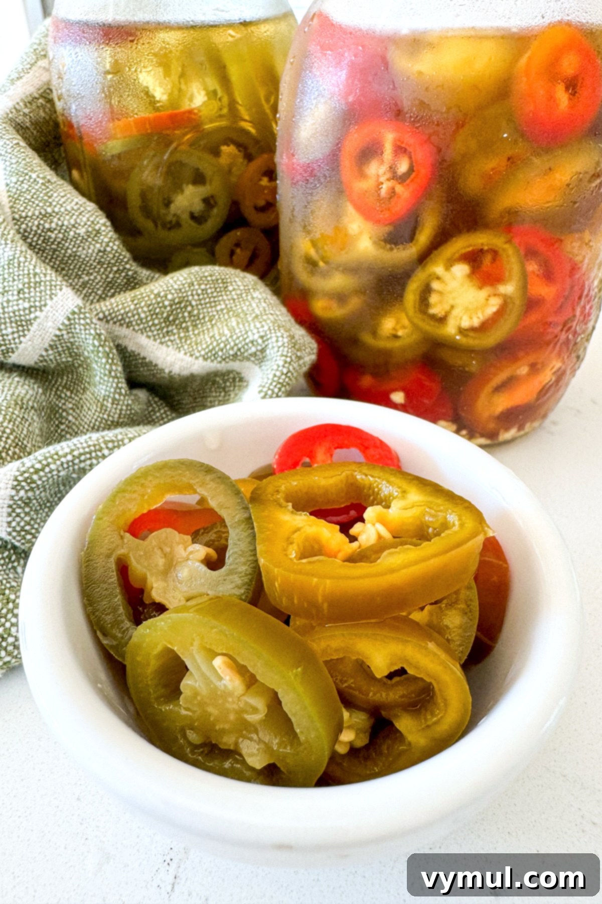 small white bowl with sliced pickled jalapeños