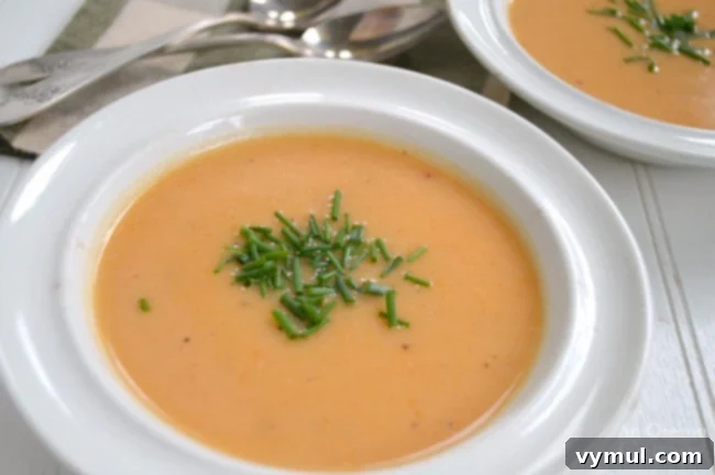 Effortless Sausage, Bean, Spinach, and Tomato Soup (Slow Cooker or Instant Pot) 9 Cauliflower Cheese Soup in a white bowl, garnished with herbs