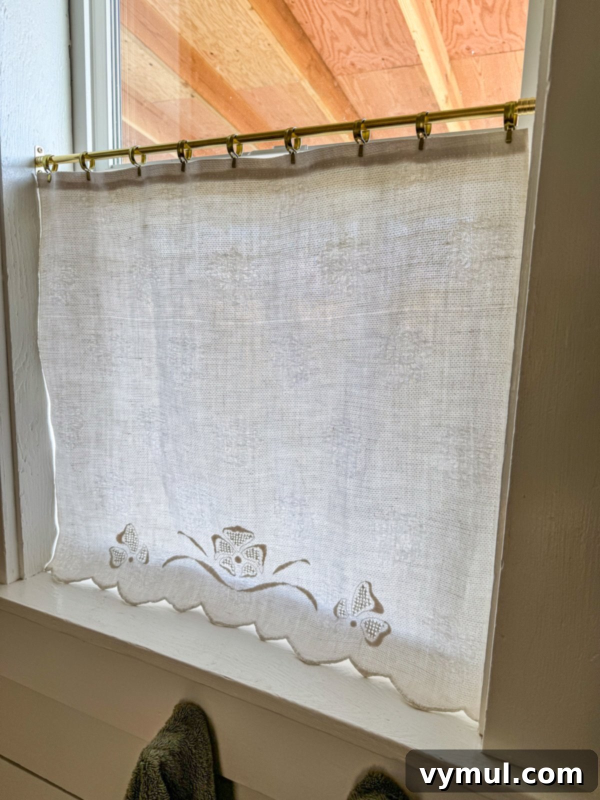 Vintage linen cafe curtain in the bathroom, shown in its closed position for privacy