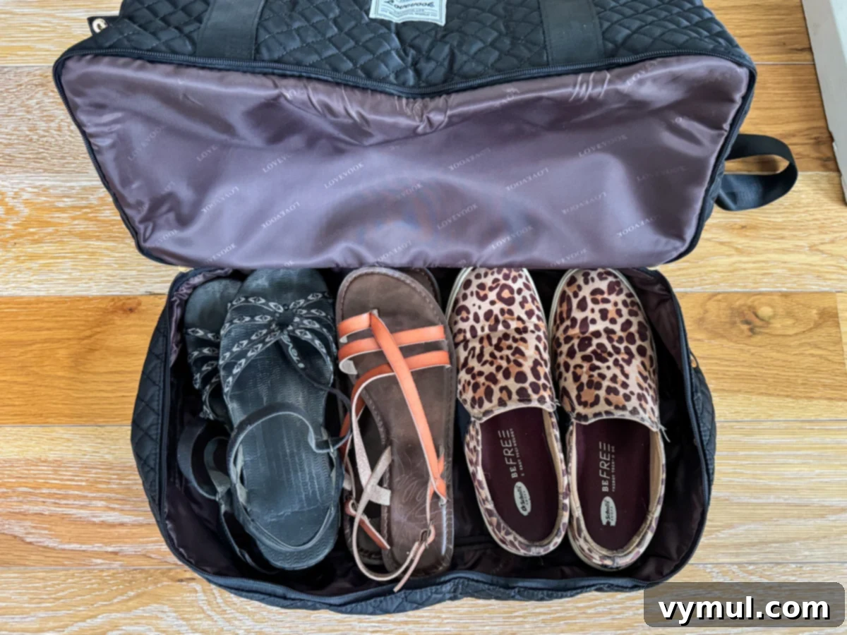Close-up view of the dedicated shoe compartment at the bottom of the weekender bag, neatly storing footwear