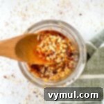 Chili crisp on a wooden spoon, ready to be served