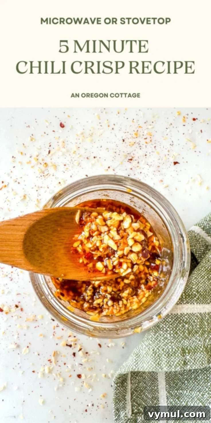 Chili crisp recipe Pinterest image: a jar of homemade chili crisp with a spoon, highlighting its crunchy texture and rich color, next to a bowl of noodles